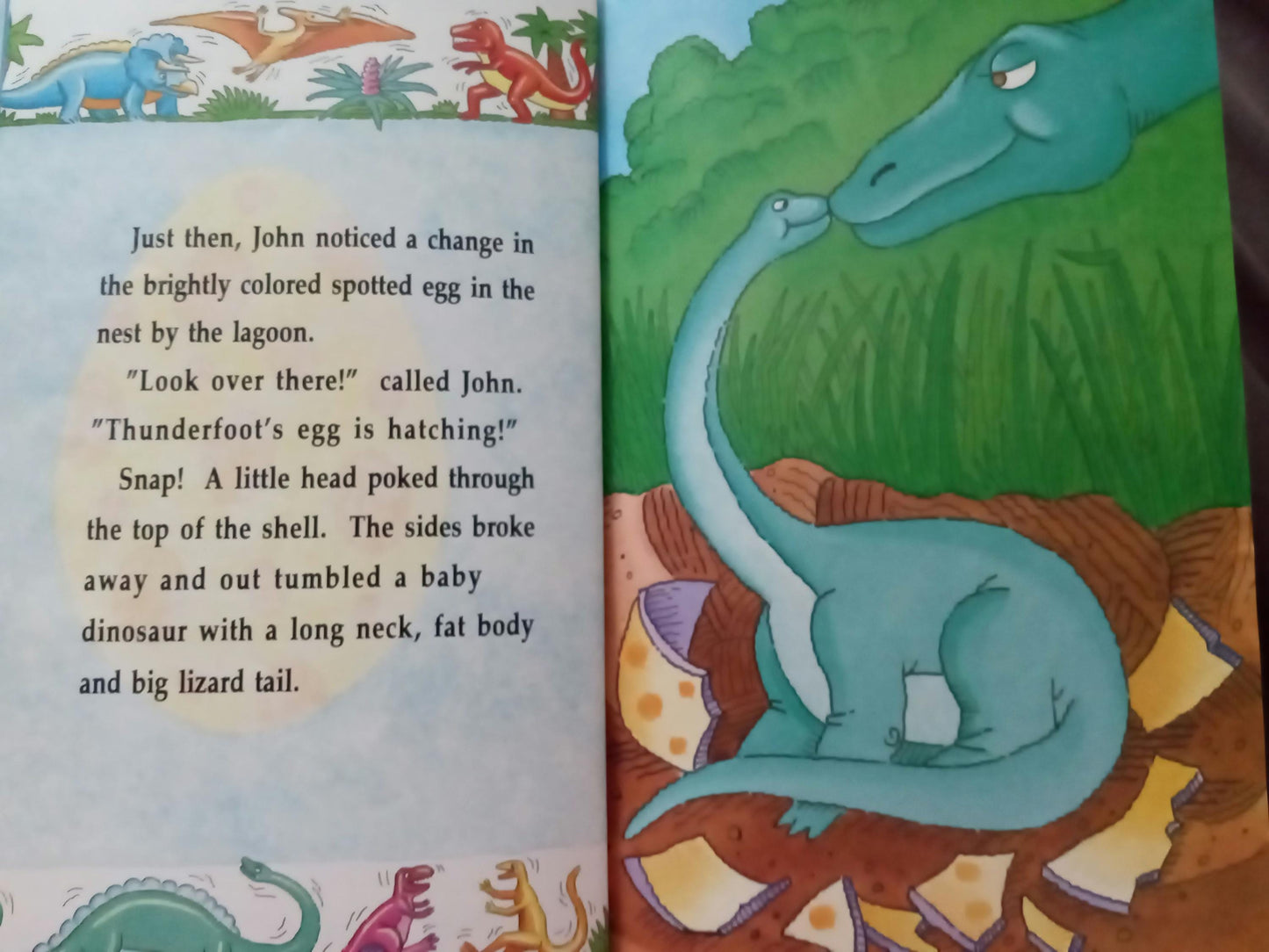 Open personalized book page with dinosaur illustration and personalized text about a hatching baby dinosaur.