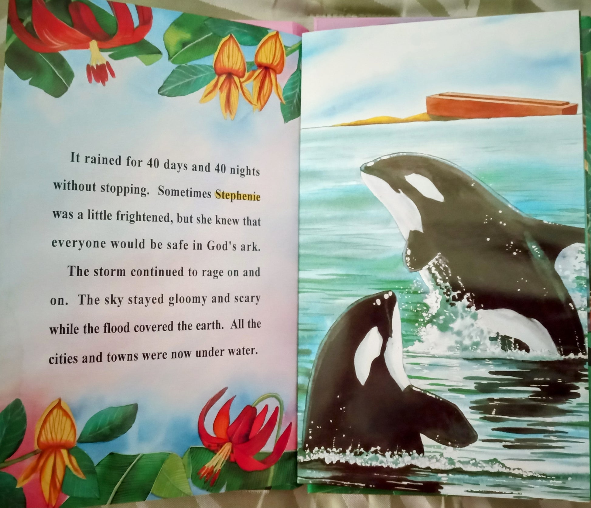 Open personalized book with illustrations of orcas and personalized text on a colorful background Noah's Ark