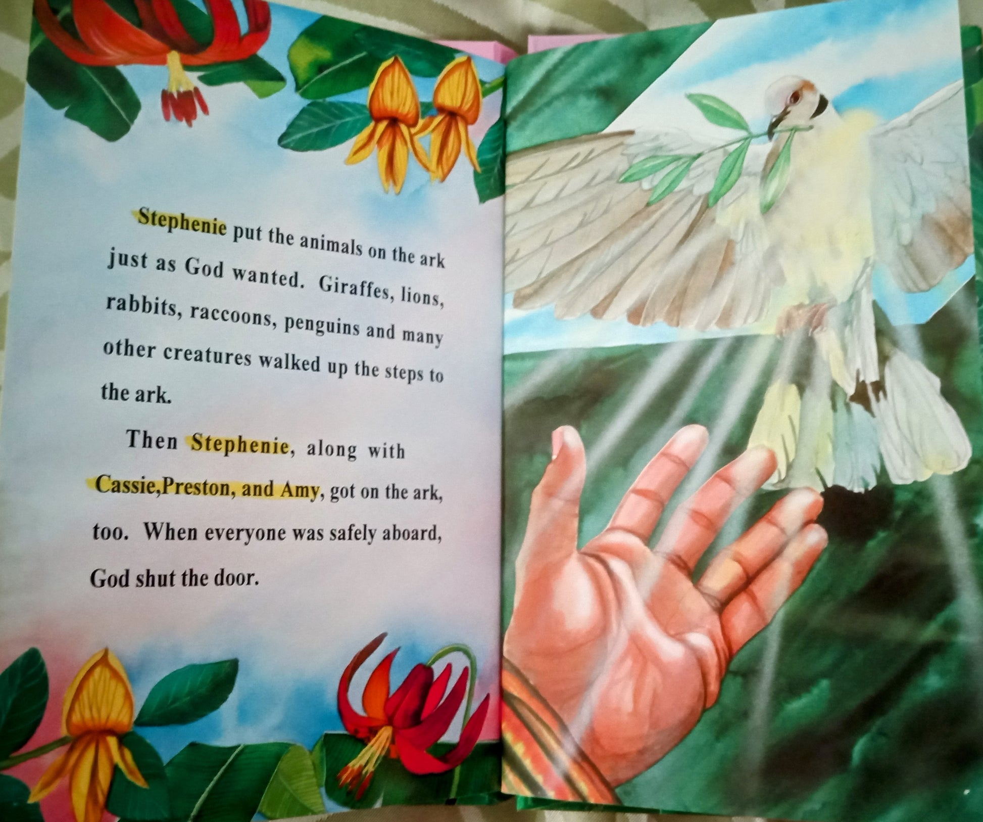 Children's personalized book open to a page with a dove and text about animals on an ark.