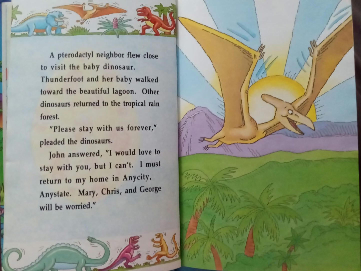 Children's personalized book open to a page with dinosaur illustrations and personalized text.
