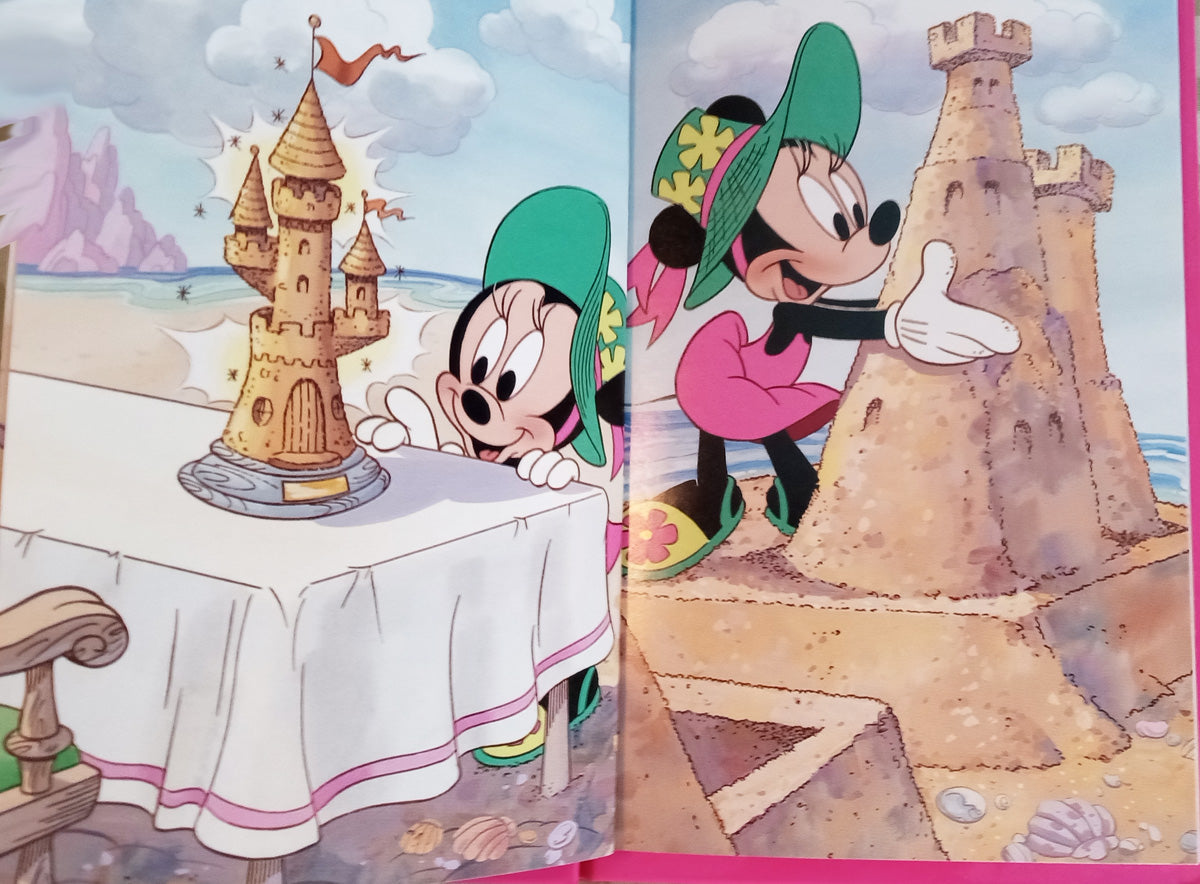 Minnie surveys the sand castle she built in personalized book - The Lollipop Guild